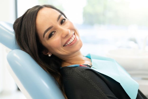 Patient smiling in a dental chair during a cosmetic dentistry consultation