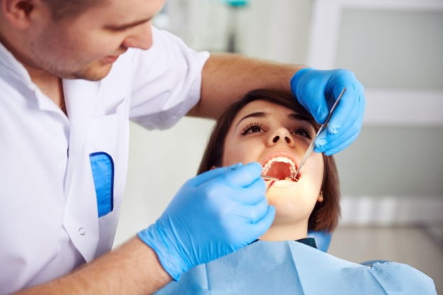Dentist replacing old fillings and dental work that no longer blends in