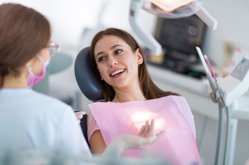 Patient talking with a dentist during a dental appointment in Markham