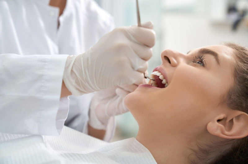 Patient receiving a dental examination as part of long-term oral health care