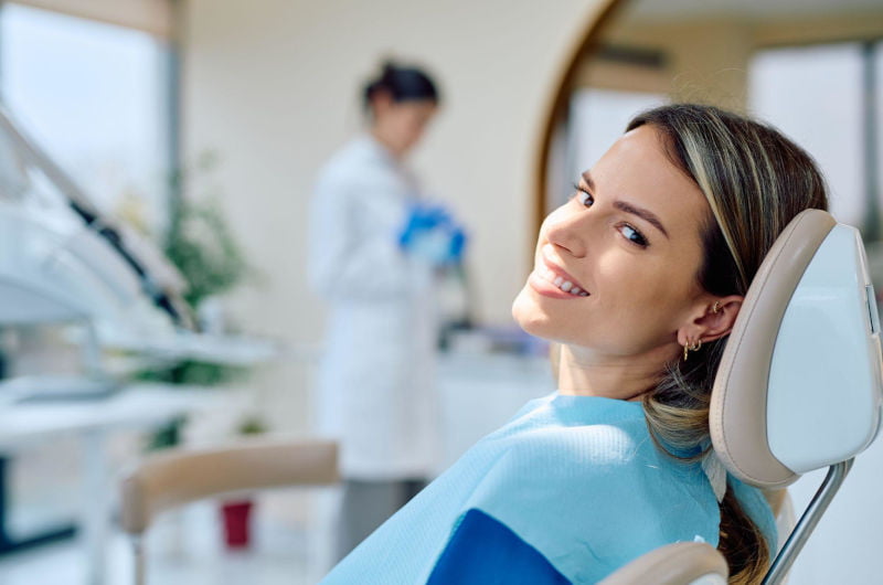 Smiling patient receiving preventive dental care at a dental clinic