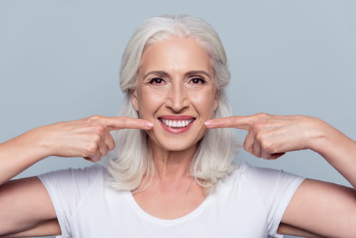 Healthy, straight white teeth demonstrating the natural appearance and aesthetic results of a single dental implant.